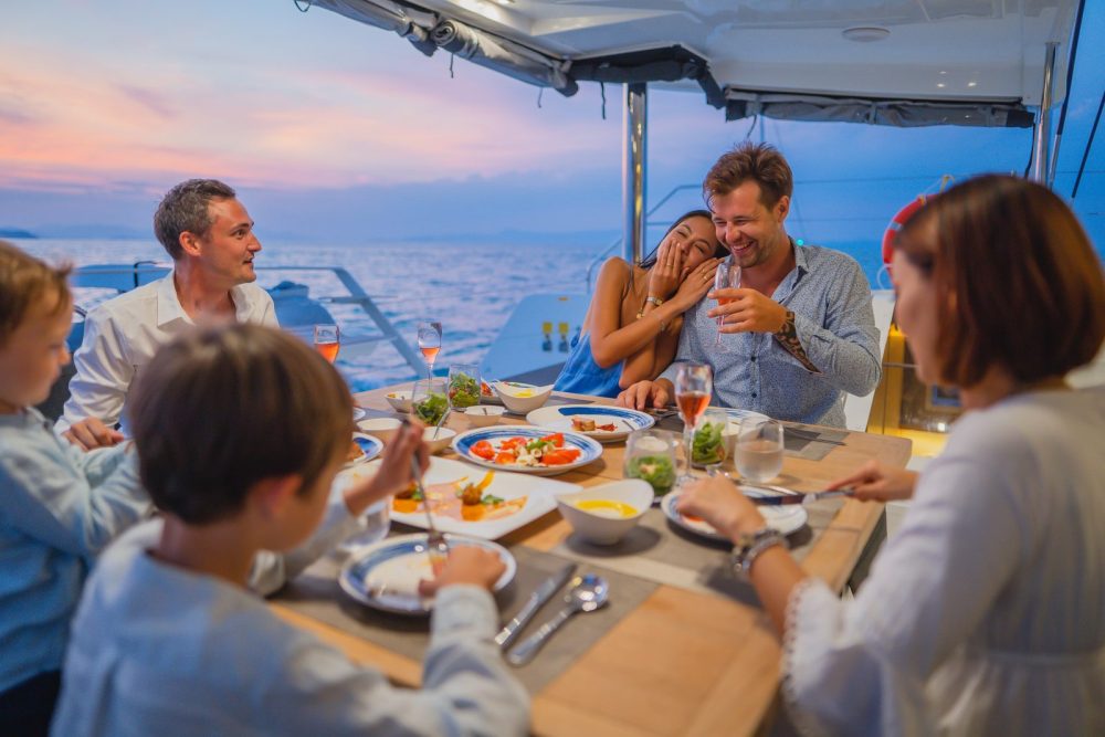 Enjoying food on board a yacht charter with friends and family