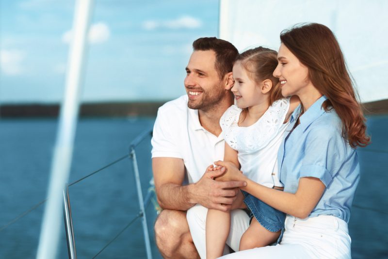 Family,Adventure,On,Yacht.,Happy,Parents,And,Kid,Yachting,Sitting